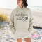 Sand pullover hoodie displaying a black airplane mode script and plane graphic.