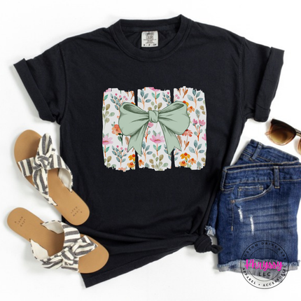 Black tee with a sage green bow over watercolor wildflower panels