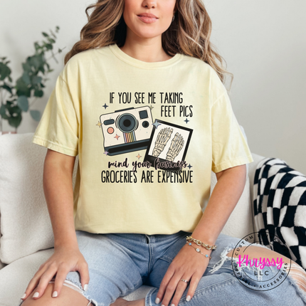 Butter tee with a vintage Polaroid camera and mind your business humor