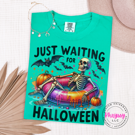 Island Green tee with a skeleton relaxing on a pool float Halloween print
