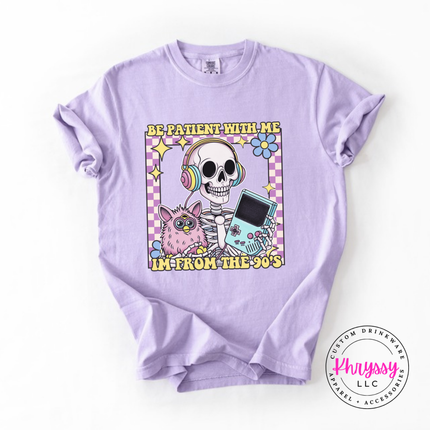 Orchid tee showing a laid-back skeleton in front of a striped retro sunset.