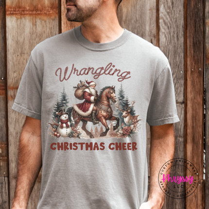 Wrangling Christmas Cheer tee in Grey featuring Santa on horseback.