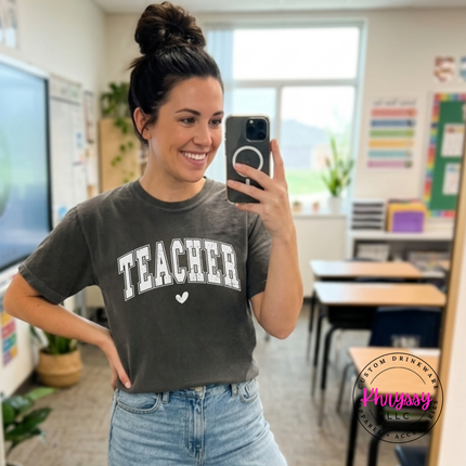 Teacher taking a classroom selfie in a Pepper Teacher varsity tee.