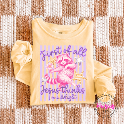 Butter yellow long sleeve tee featuring a raccoon holding a daisy with stars