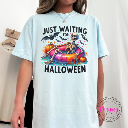 Chambray tee featuring a Just Waiting for Halloween skeleton on a pool float