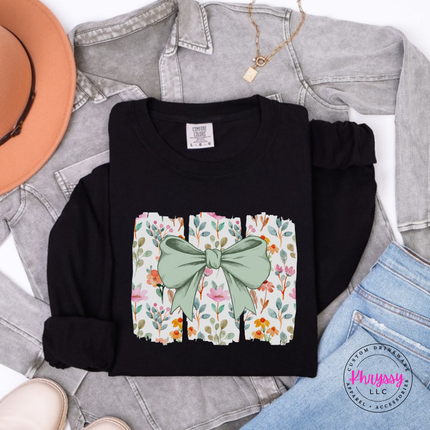 Black long sleeve tee with a sage green bow over watercolor wildflower panels