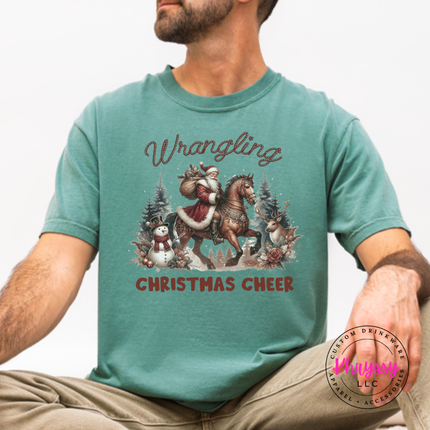 Wrangling Christmas Cheer tee in Light Green featuring Santa on horseback.