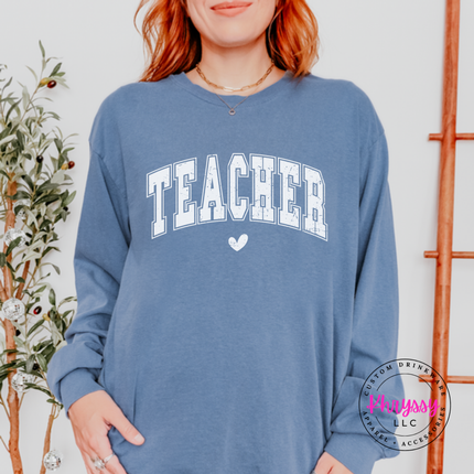 Woman wearing a Blue Jean long sleeve tee with vintage Teacher varsity lettering.