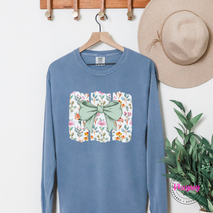 Blue Jean long sleeve tee with a sage green bow over watercolor wildflower panels