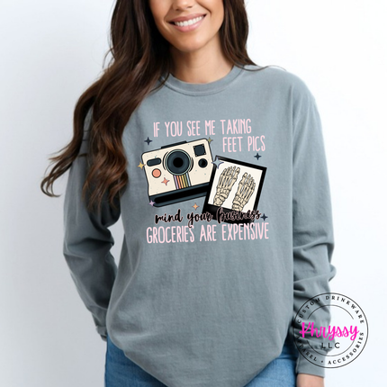 Grey long sleeve tee with a retro camera and skeleton feet graphic in pink