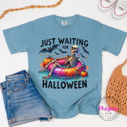 Ice Blue tee with a Just Waiting for Halloween skeleton pool float print