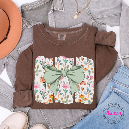 Espresso brown long sleeve tee with a sage green bow over watercolor wildflower panels
