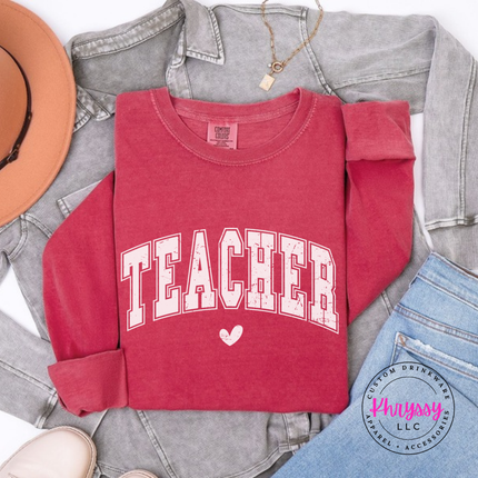 Flat lay of a Crimson long sleeve tee with a retro Teacher varsity arch.