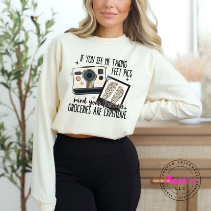 Ivory long sleeve tee with a retro camera and skeleton feet humor graphic