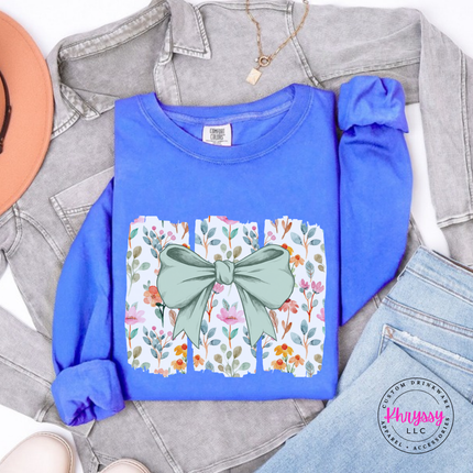Fluorescent Blue long sleeve tee with a sage green bow over watercolor wildflower panels
