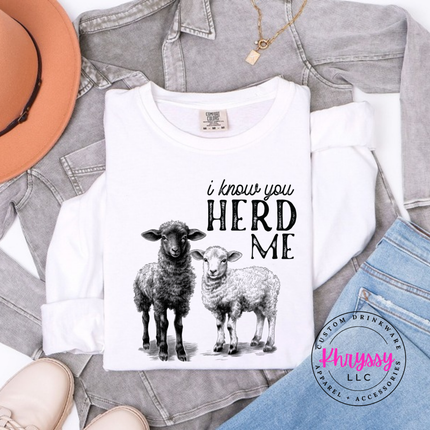 White long sleeve tee with two sheep and the words i know you herd me