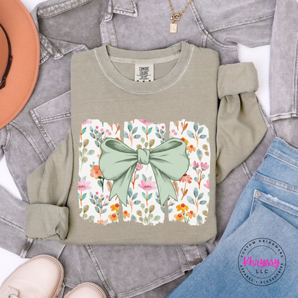 Khaki long sleeve tee with a sage green bow over watercolor wildflower panels