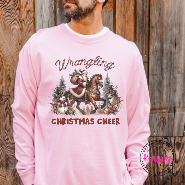 Wrangling Christmas Cheer long sleeve tee in Blossom featuring Santa on horseback.
