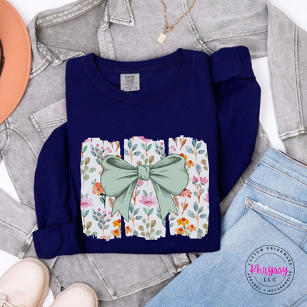 True Navy long sleeve tee with a sage green bow over watercolor wildflower panels
