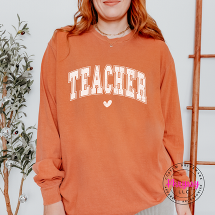 Woman wearing a Yam long sleeve tee with a retro Teacher varsity arch print.