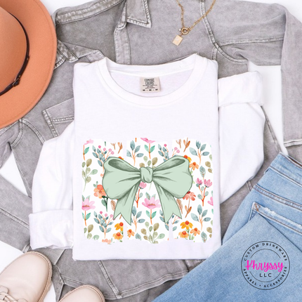 White long sleeve tee with a sage green bow over watercolor wildflower panels