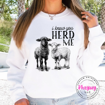 White crewneck sweatshirt with two sheep and the words i know you herd me