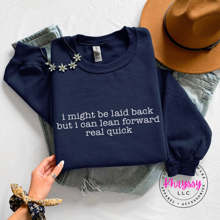 Navy crewneck sweatshirt with white typewriter quote about being laid back but leaning forward.