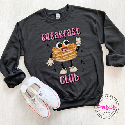 Black crewneck sweatshirt featuring a retro pancake stack with tiny legs and Breakfast Club lettering.