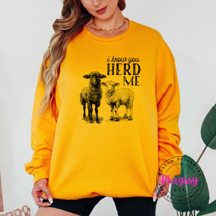 Gold crewneck sweatshirt with two sheep and the words i know you herd me