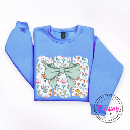 Carolina Blue crewneck sweatshirt with a sage green bow over watercolor wildflower panels
