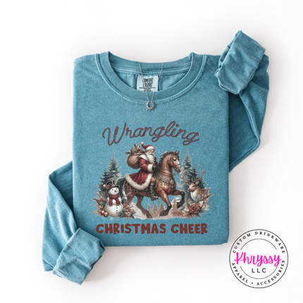 Wrangling Christmas Cheer long sleeve tee in Ice Blue featuring Santa on horseback.