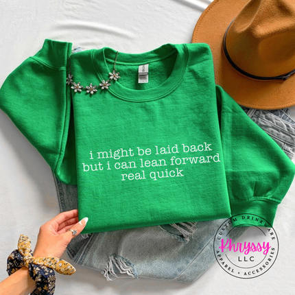 Irish Green crewneck sweatshirt with white typewriter quote about being laid back but leaning forward.