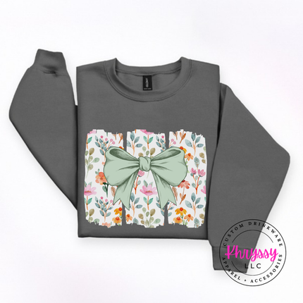Charcoal crewneck sweatshirt with a sage green bow over watercolor wildflower panels