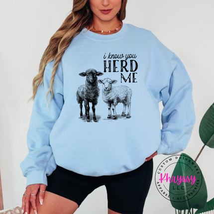 Light Blue crewneck sweatshirt with two sheep and the words i know you herd me