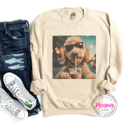 Sand crewneck sweatshirt with a retro goldendoodle in sunglasses sipping iced coffee print.