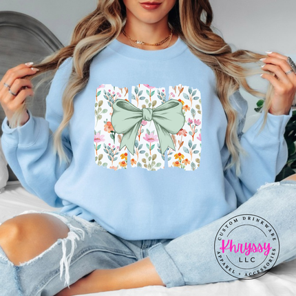 Light Blue crewneck sweatshirt with a sage green bow over watercolor wildflower panels