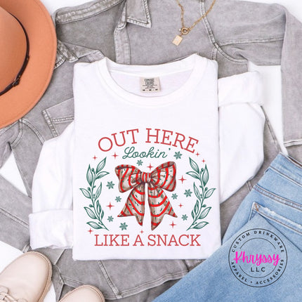 White long sleeve tee with the Lookin Like A Snack candy cane bow.