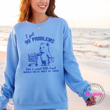 Close up of the treat bear art on a Carolina Blue crewneck sweatshirt.