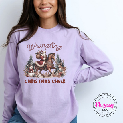 Wrangling Christmas Cheer long sleeve tee in Orchid featuring Santa on horseback.