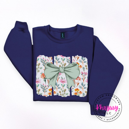 Navy crewneck sweatshirt with a sage green bow over watercolor wildflower panels