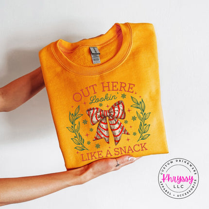 Gold crewneck sweatshirt with the Lookin Like A Snack candy cane bow.