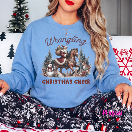 Wrangling Christmas Cheer crewneck sweatshirt in Carolina Blue featuring Santa on horseback.