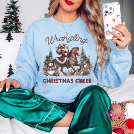 Wrangling Christmas Cheer crewneck sweatshirt in Light Blue featuring Santa on horseback.