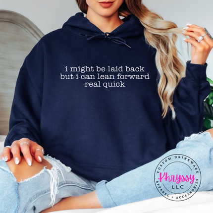 Navy hoodie with white typewriter quote about being laid back but leaning forward.