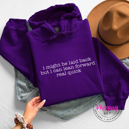 Purple hoodie with white typewriter quote about being laid back but leaning forward.