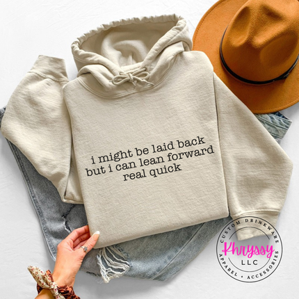 Sand hoodie with black typewriter quote about being laid back but leaning forward.