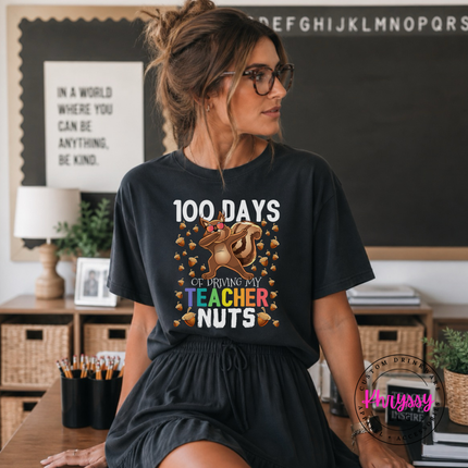 Woman wearing a Black 100 days driving my teacher nuts squirrel tee.