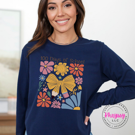 Vibrant floral bow 100 days long sleeve on Navy Bella Canvas with warm pink and gold flower detail