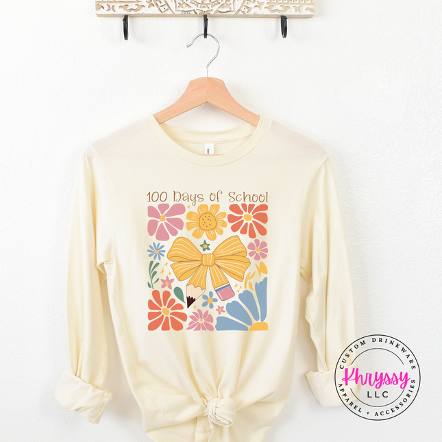 Rich 100 days of school floral bow long sleeve on natural Bella Canvas with warm botanical bow graphic