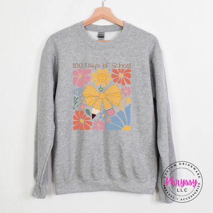 Vibrant floral bow 100 days crewneck on sport grey Gildan with warm pink and gold flower graphic